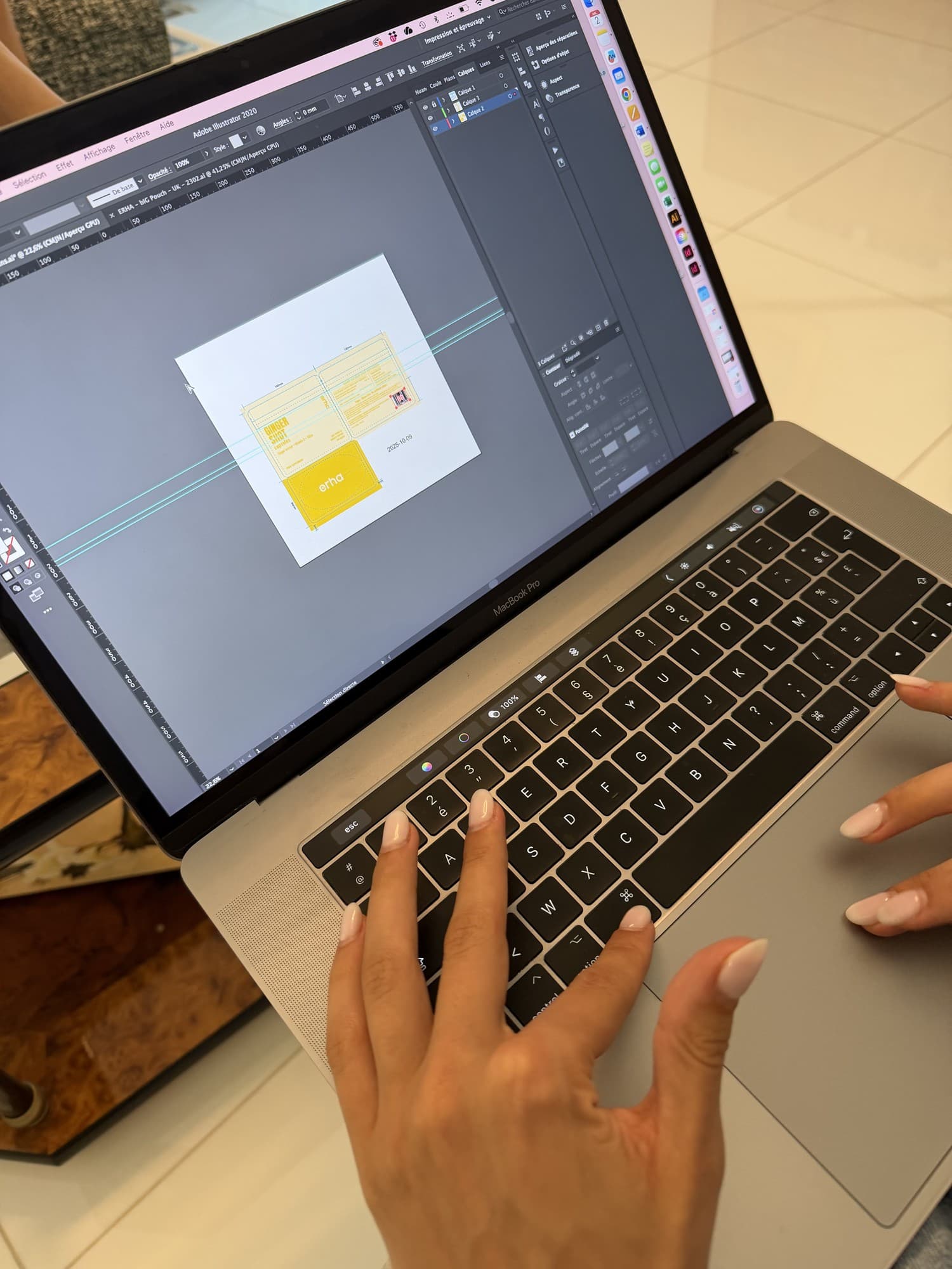 Designing the Erha Pocket Shots packaging on a laptop